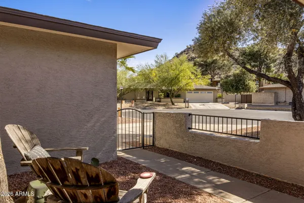 a view of a patio with iron fence