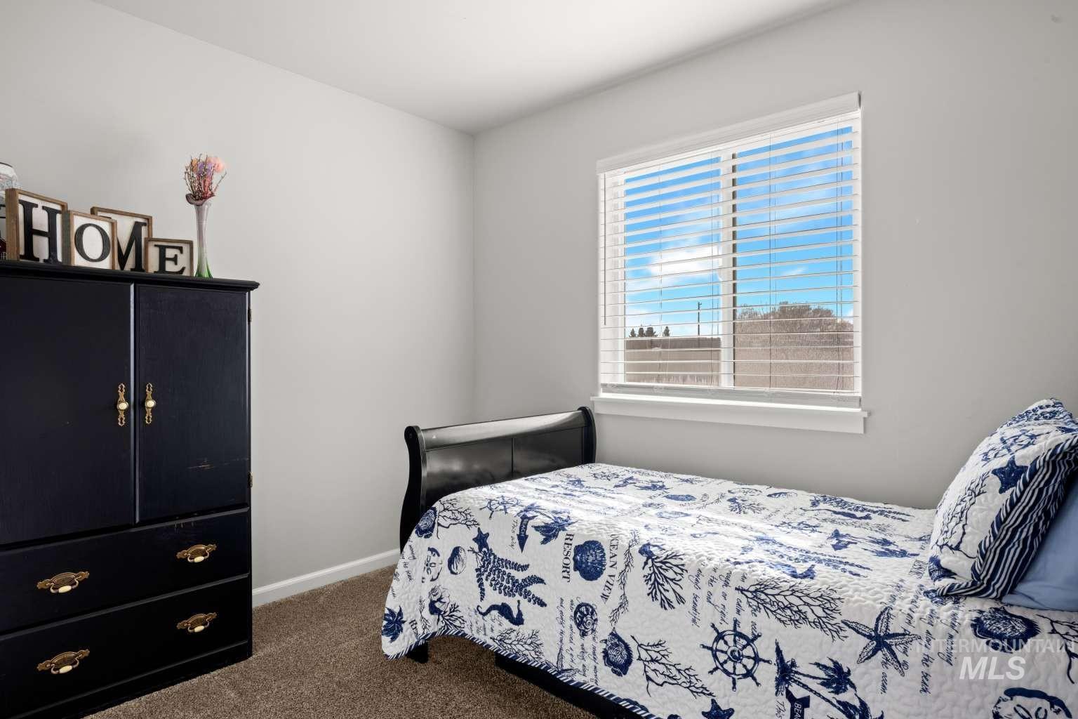 521 East 15th Street Rupert, ID 83350 - Photo 15 of 21 Bedroom featuring dark carpet and baseboards