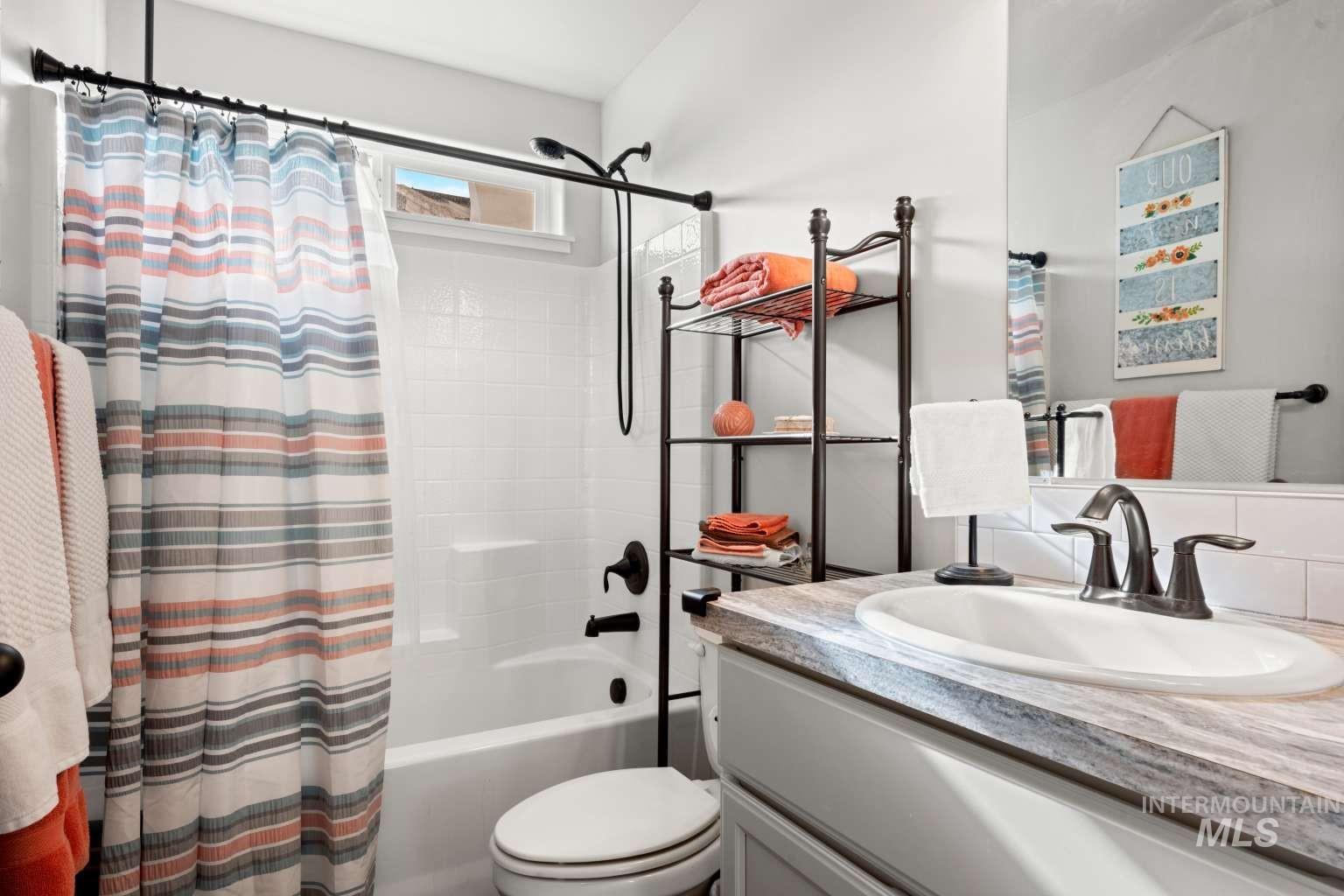 521 East 15th Street Rupert, ID 83350 - Photo 18 of 21 Bathroom featuring shower / bathtub combination with curtain and vanity