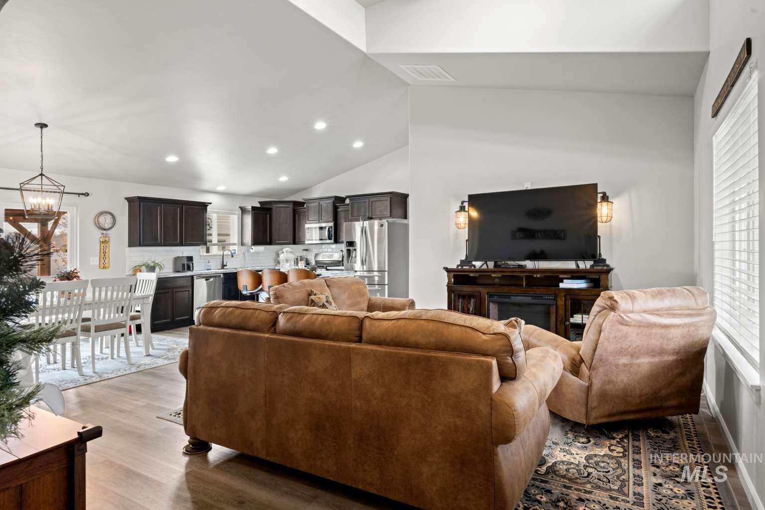 521 East 15th Street Rupert, ID 83350 - Photo 7 of 21 Living room featuring light wood finished floors, recessed lighting, high vaulted ceiling, and a chandelier