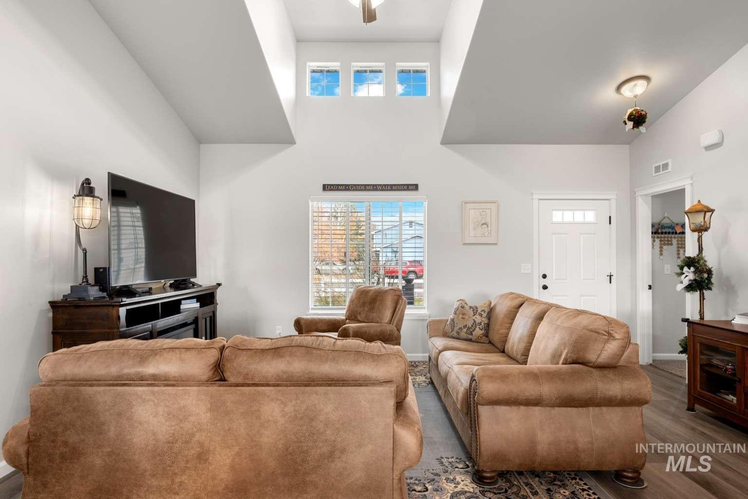 521 East 15th Street Rupert, ID 83350 - Photo 8 of 21 Living area featuring wood finished floors and a high ceiling