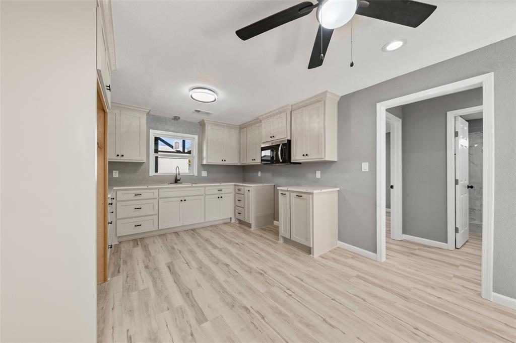 108 9th Street Valley Mills, TX 76689 - Photo 4 of 19 a kitchen with stainless steel appliances a white cabinets and wooden floor