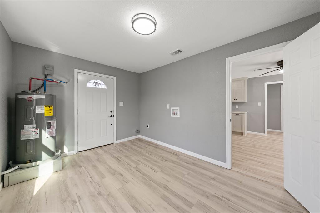 108 9th Street Valley Mills, TX 76689 - Photo 10 of 19 wooden floor in an empty room with a window