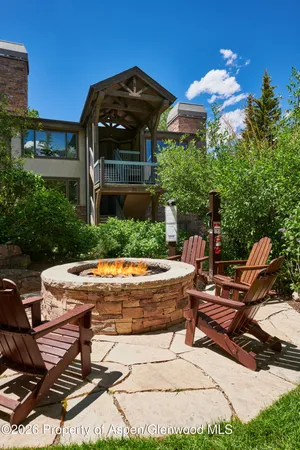 a view of a chairs and table in backyard