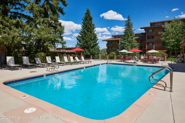 a swimming pool with outdoor seating and yard