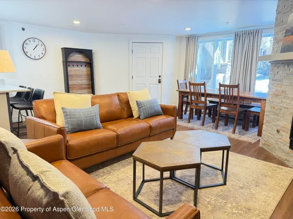 a living room with furniture wooden floor and a window