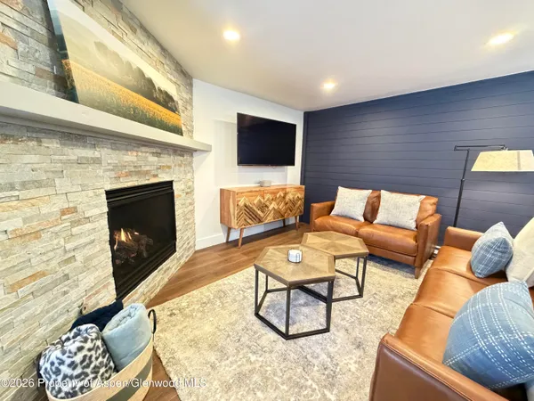 a living room with furniture and a fireplace