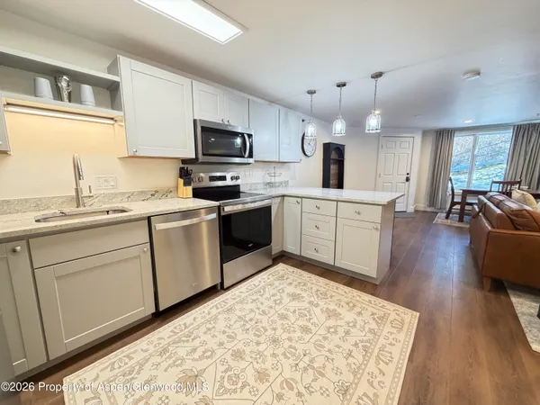 a kitchen with a sink stove and cabinets