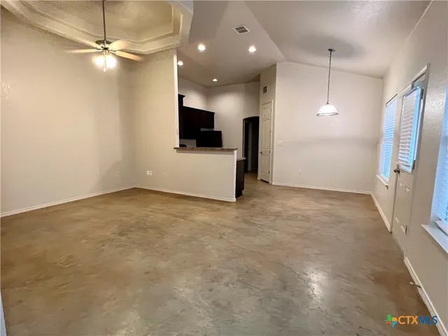 a view of a kitchen with a flat screen tv and a refrigerator