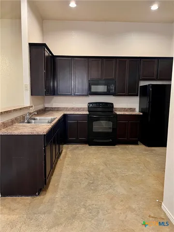 a kitchen with a sink and cabinets