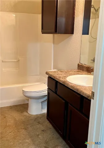a view of backyard with wooden fence and large windows
