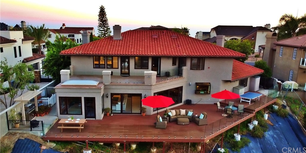 868 Avenida Acapulco San Clemente, CA 92672 - Photo 45 of 52 Aerial view of the backyard and the wrap around Azek deck. Slope covered with tarp to prevent weed growth
