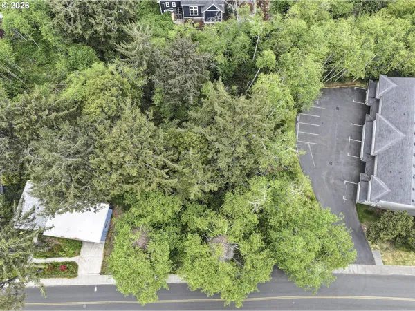 an aerial view of a house with yard