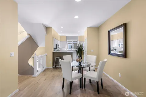 a dining room with furniture and wooden floor