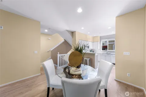 a dining room with furniture and wooden floor