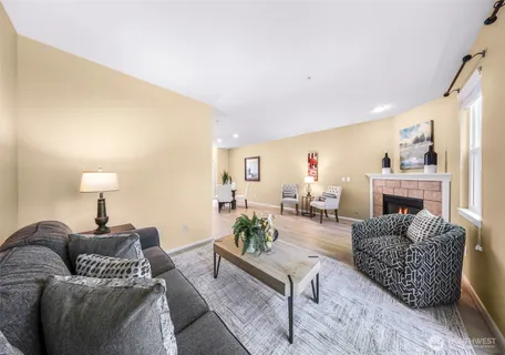 a living room with furniture a lamp and a flat screen tv
