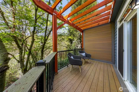 a balcony with wooden floor and outdoor seating