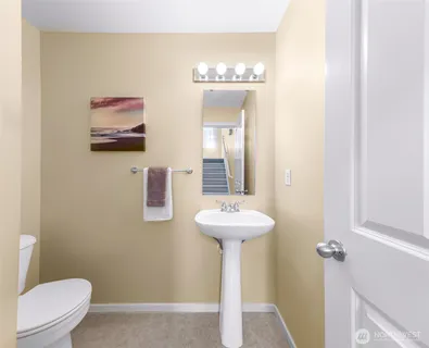 a bathroom with a sink a mirror and toilet