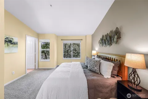 a bedroom with a large bed and a couch