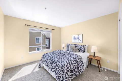 a bedroom with a bed and a lamp