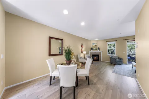 a living room with furniture a fireplace and wooden floor