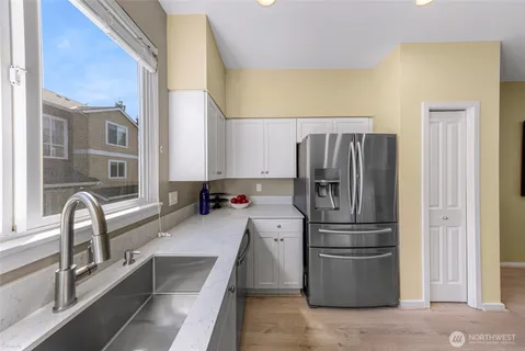 a kitchen with a refrigerator and a sink