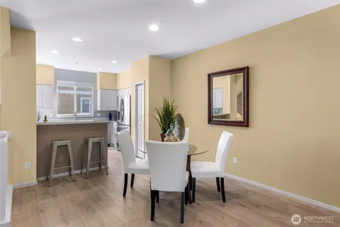 a view of a dining room with furniture and a potted plant