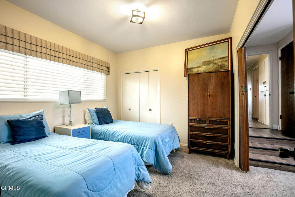 1235 Capri Way Oxnard, CA 93035 - Photo 16 of 21 a bedroom with two bed and a large mirror