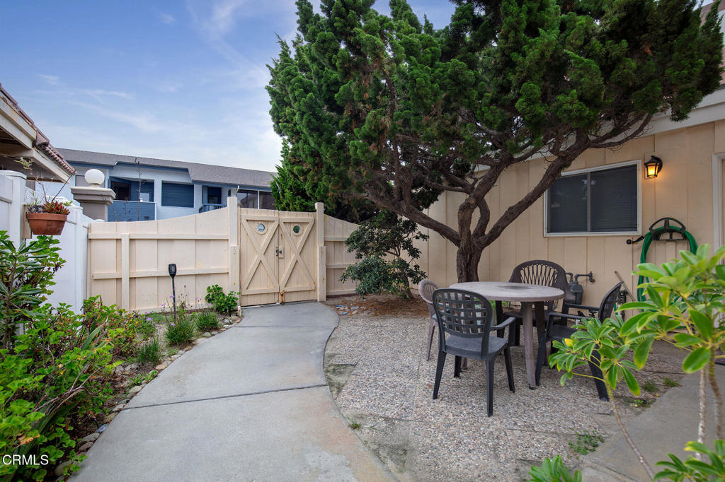1235 Capri Way Oxnard, CA 93035 - Photo 8 of 21 a view of a patio with table and chairs and potted plants