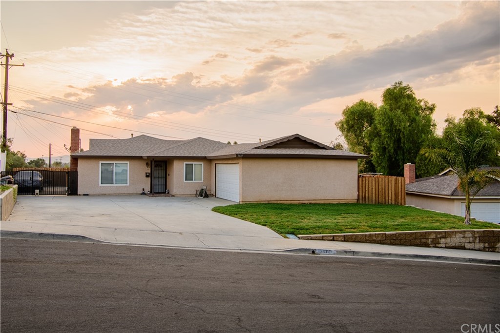 3410 Toulon Court Riverside, CA 92501 - Photo 1 of 1 a front view of a house with a yard and garage