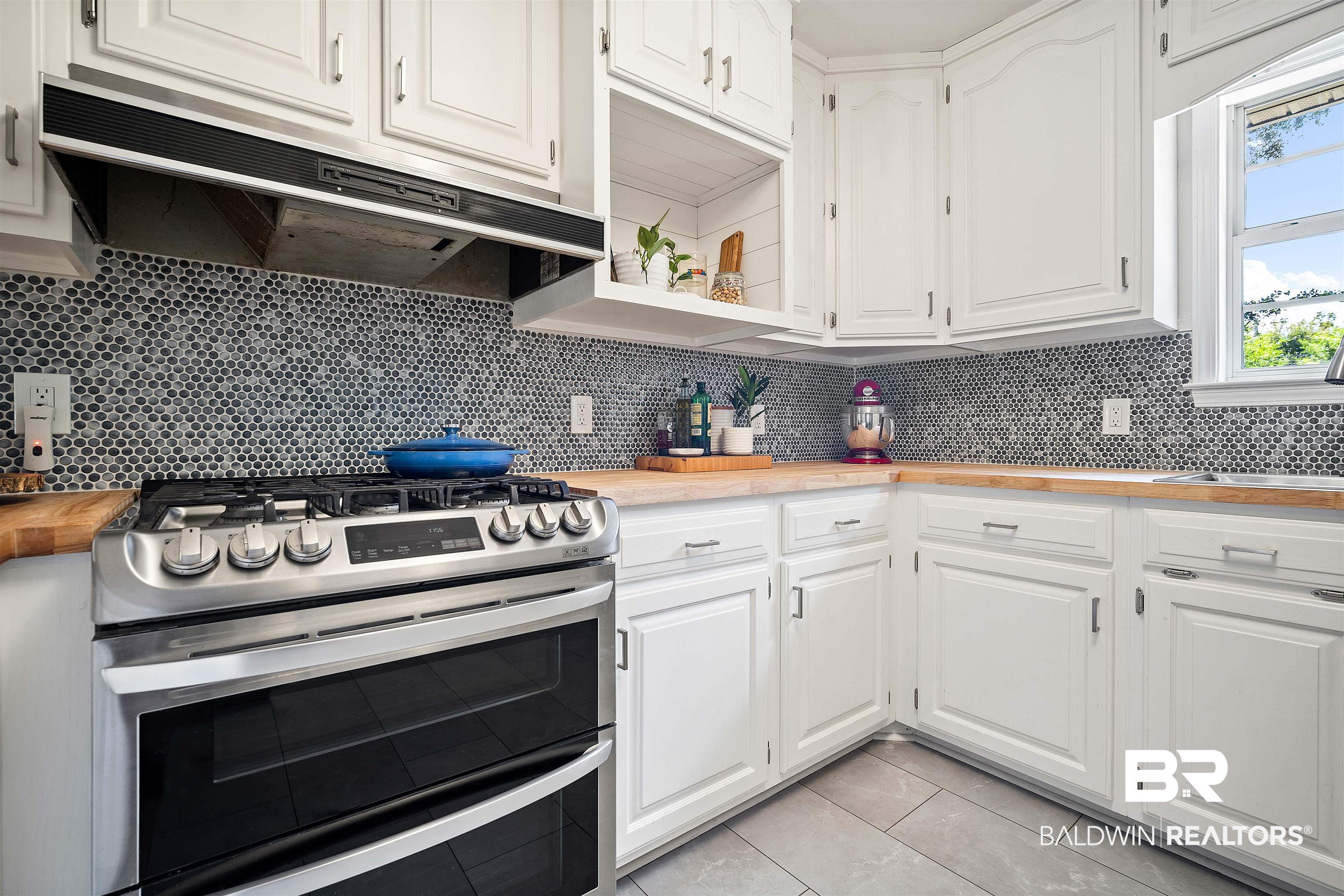 808 Michigan Avenue Fairhope, AL 36532 - Photo 10 of 33 Kitchen featuring stainless steel range with gas cooktop, decorative backsplash, wooden counters, and white cabinets