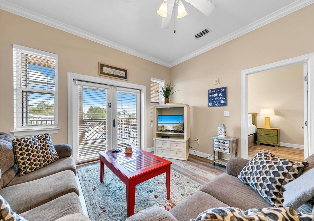 231 Somerset Bridge Road, Unit 2308 Santa Rosa Beach, FL 32459 - Photo 13 of 47 a living room with furniture a flat screen tv and a chandelier