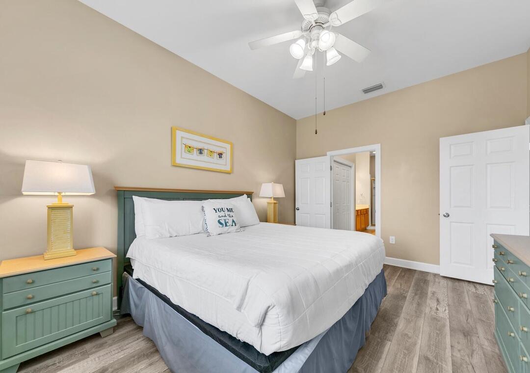 231 Somerset Bridge Road, Unit 2308 Santa Rosa Beach, FL 32459 - Photo 19 of 47 a bedroom with a bed and a chandelier