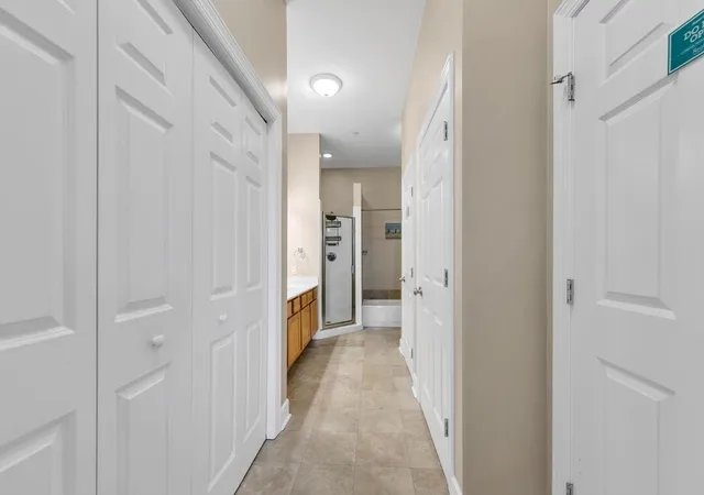 a view of a hallway with a wooden floor
