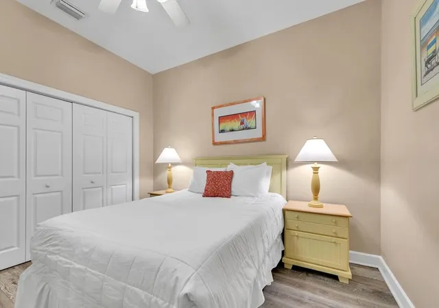 a bedroom with a bed and a lamp