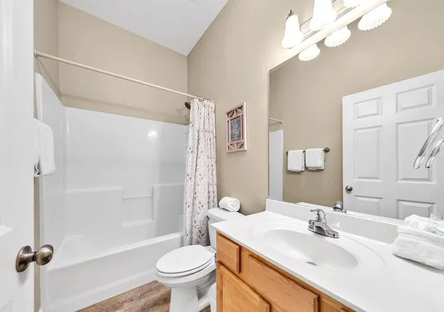 a bathroom with a sink toilet tub and shower