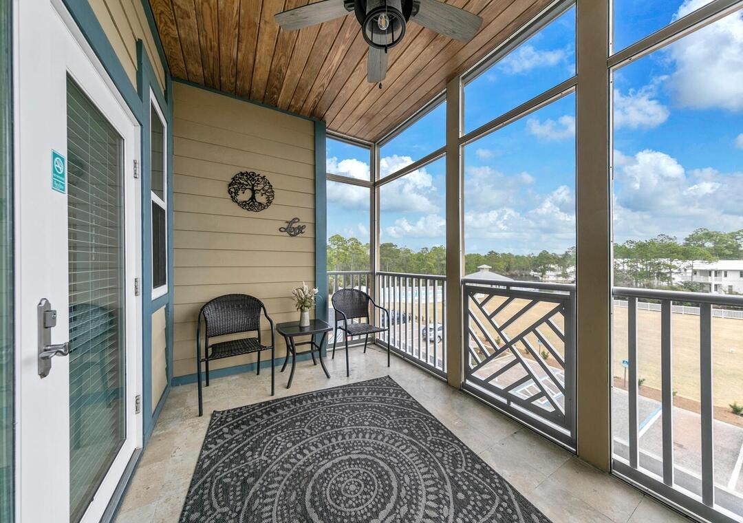 231 Somerset Bridge Road, Unit 2308 Santa Rosa Beach, FL 32459 - Photo 31 of 47 a view of a porch with furniture and floor to ceiling window