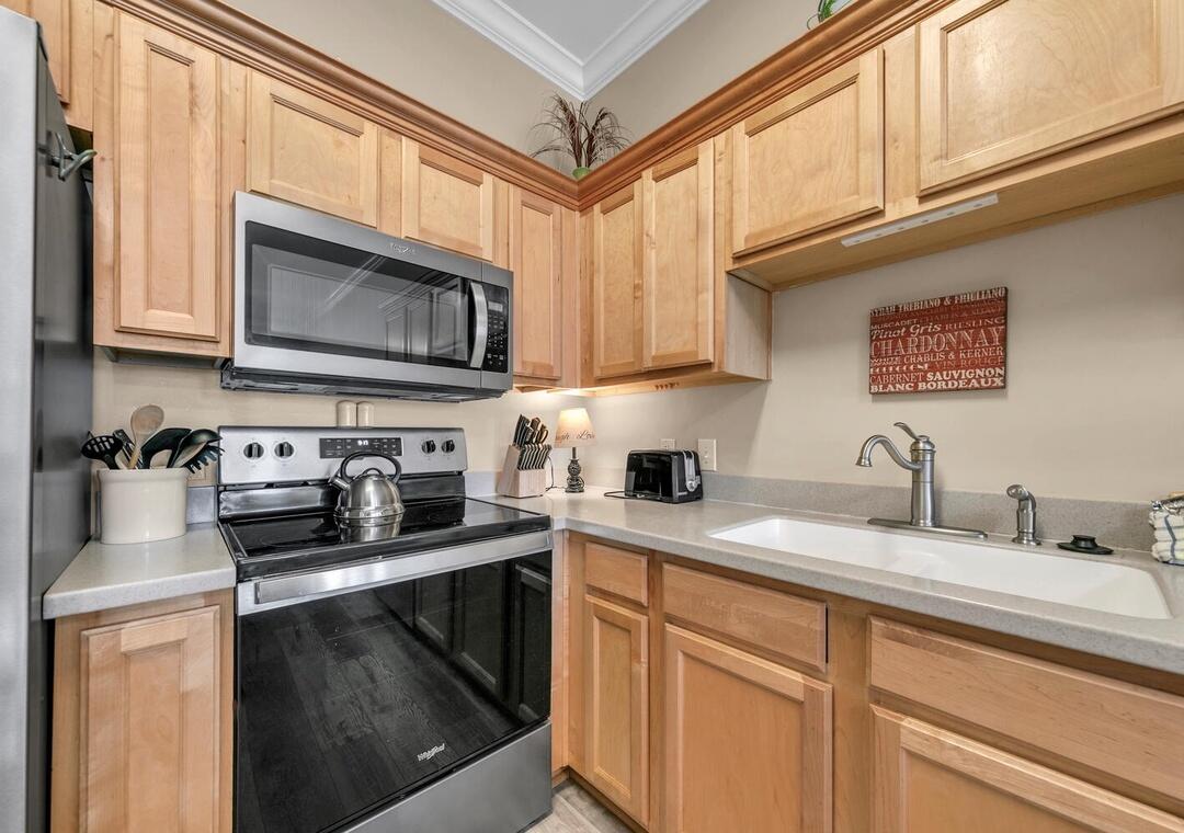 231 Somerset Bridge Road, Unit 2308 Santa Rosa Beach, FL 32459 - Photo 10 of 47 a kitchen with stainless steel appliances granite countertop a sink stove and microwave