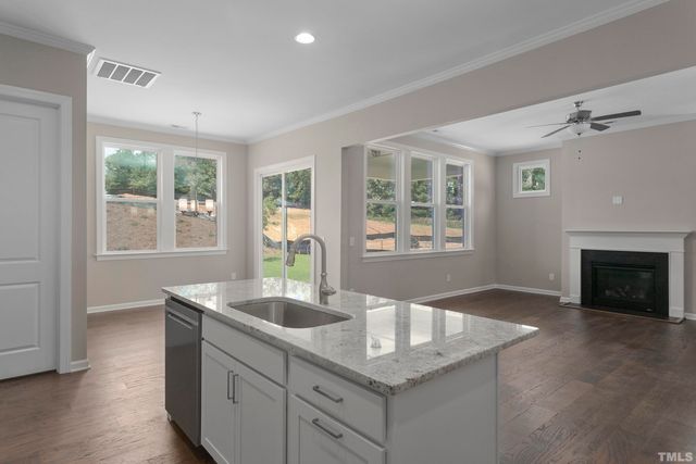 a kitchen with granite countertop a sink and a window