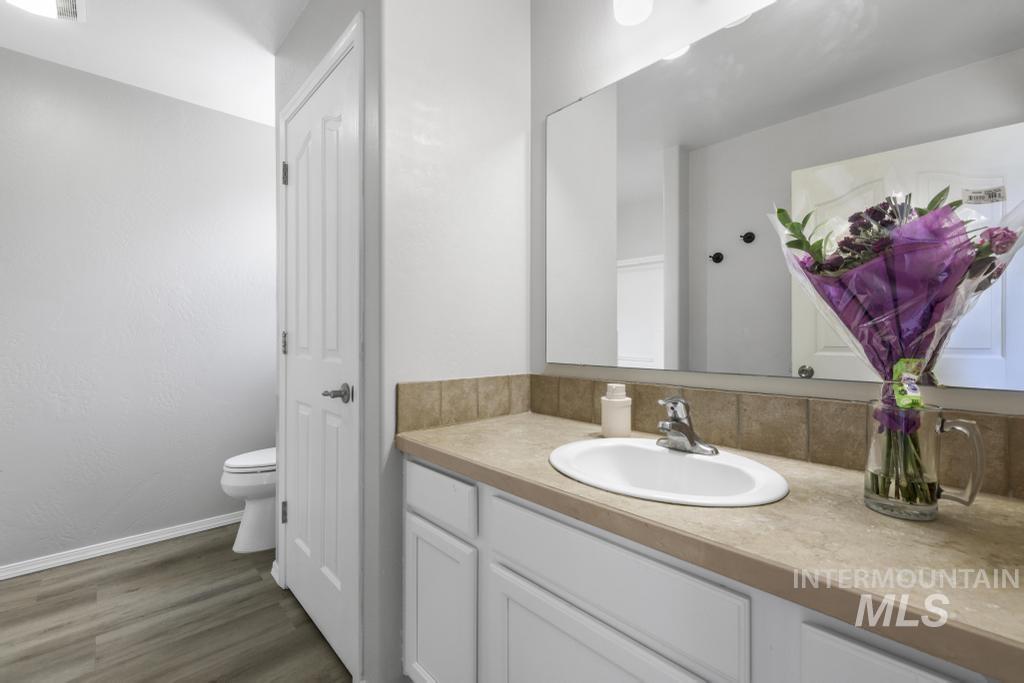 1183 Cortes Loop Twin Falls, ID 83301 - Photo 20 of 30 Bathroom vanity featuring a light-toned countertop, undermount sink, and chrome faucet