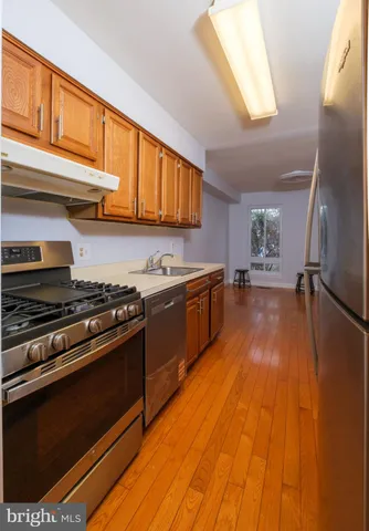 a kitchen with stainless steel appliances granite countertop a stove and a refrigerator