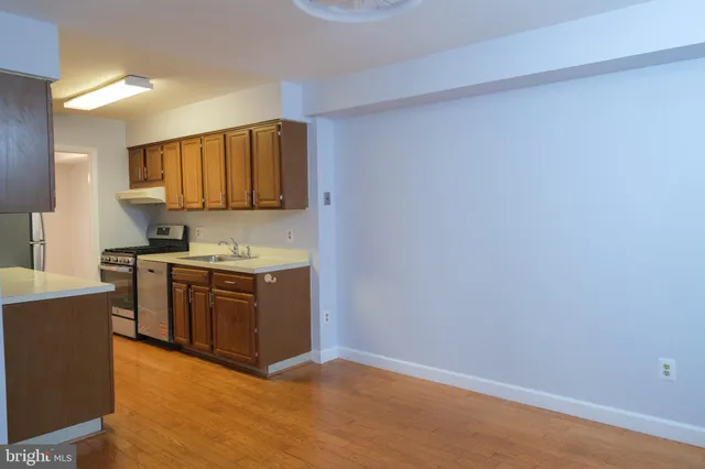 a kitchen with stainless steel appliances granite countertop a sink and a stove top oven