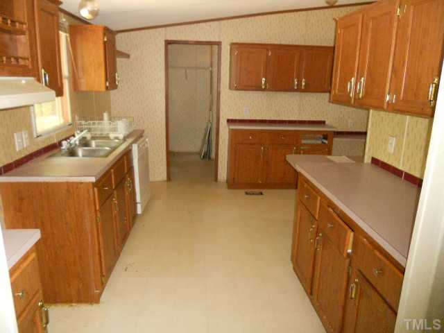 1332 Yakimas Road Raleigh, NC 27603 - Photo 6 of 9 a kitchen with a sink stove and refrigerator