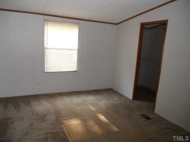 1332 Yakimas Road Raleigh, NC 27603 - Photo 7 of 9 an empty room with a window