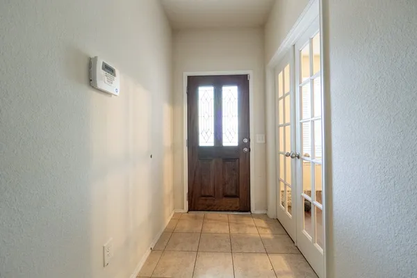 a hallway with windows and a bathroom