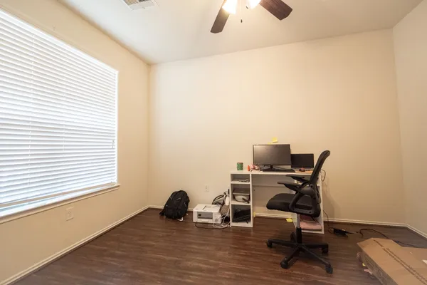 a view of a workspace with furniture and a window