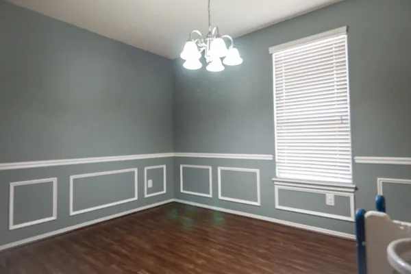 a view of wooden floor and windows in a room