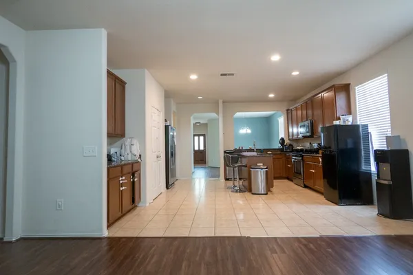 a kitchen with stainless steel appliances a refrigerator and a stove top oven