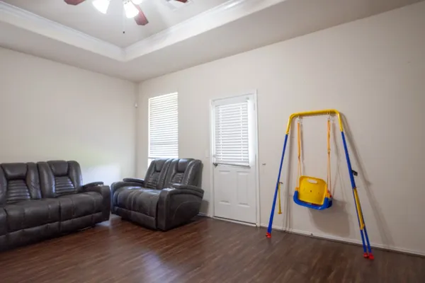 a living room with furniture and wooden floor