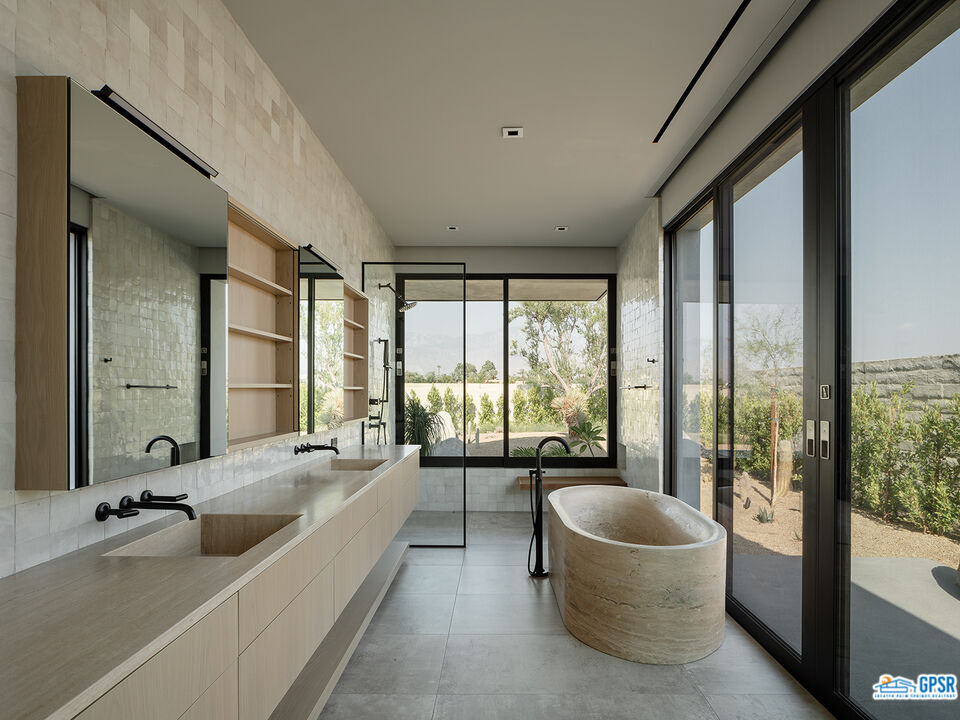 9 Echo Lane Rancho Mirage, CA 92270 - Photo 11 of 12 a spacious bathroom with a large tub and large windows